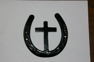 THIS IS A CROSS AND A HORSHOE WELDED TOGETHER