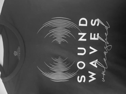 SOUND WAVES UNLEASHED: SOUND ON TOP OF WAVES, BOTH WORDS IN UPPER CAPS PRINT, UNLEASHED ON THE BOTTOM IN LOWER CASE CURSIVE.